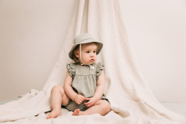 Baby wearing onesie and baby hat in pima cotton | UAUA Collections