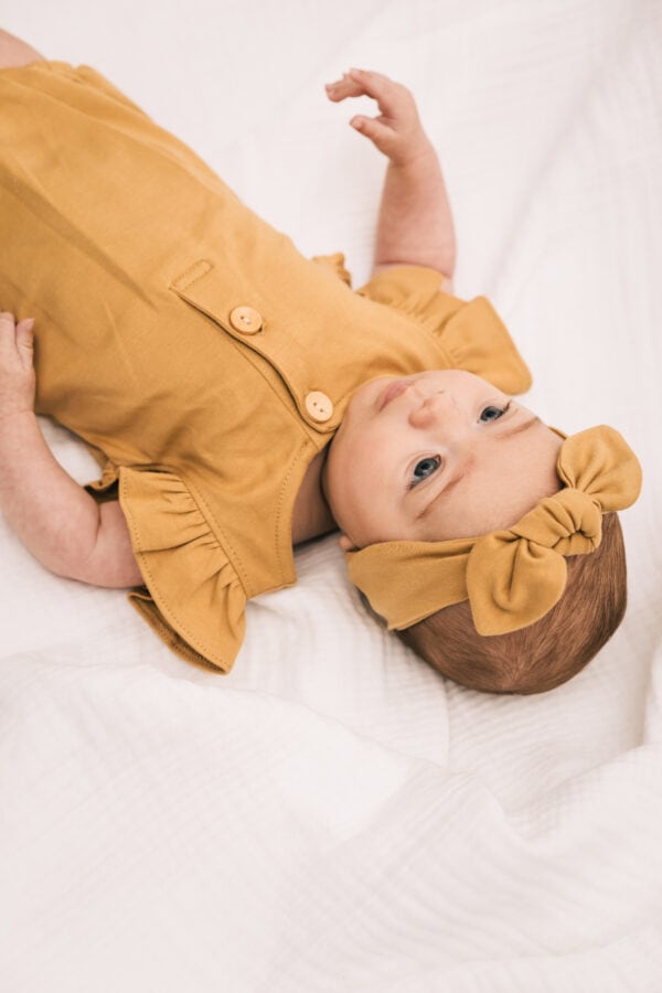 Baby wearing outfit and ribbon in pima cotton | UAUA Collections