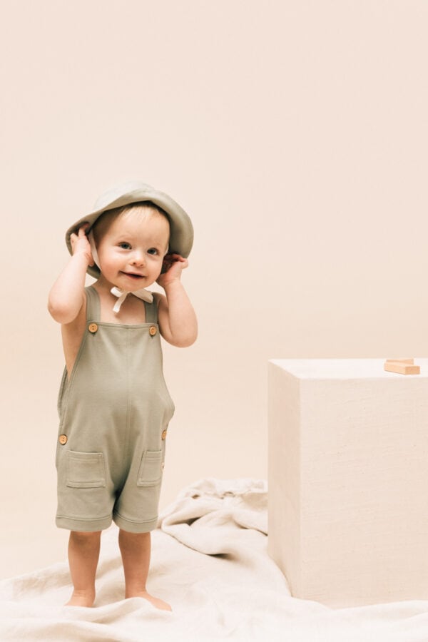 Baby wearing overall in pima cotton | UAUA Collections