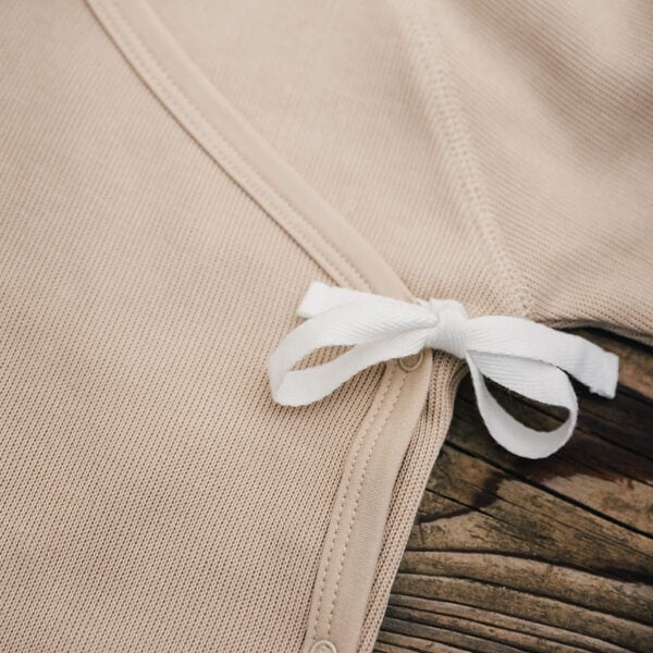Baby wearing kimono footie in pima cotton | UAUA Collections