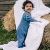 Baby wearing onesie in pima cotton in blue | UAUA Collections