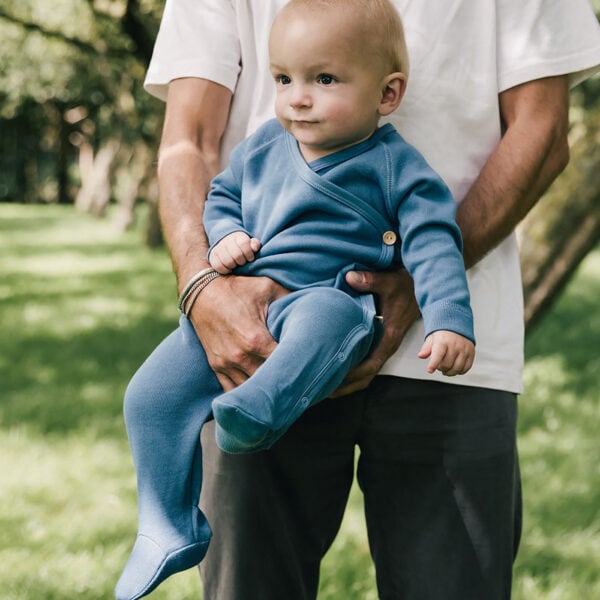 Baby wearing onesie in pima cotton in blue | UAUA Collections