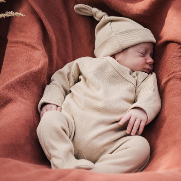 Baby wearing onesie and hat in pima cotton | UAUA Collections