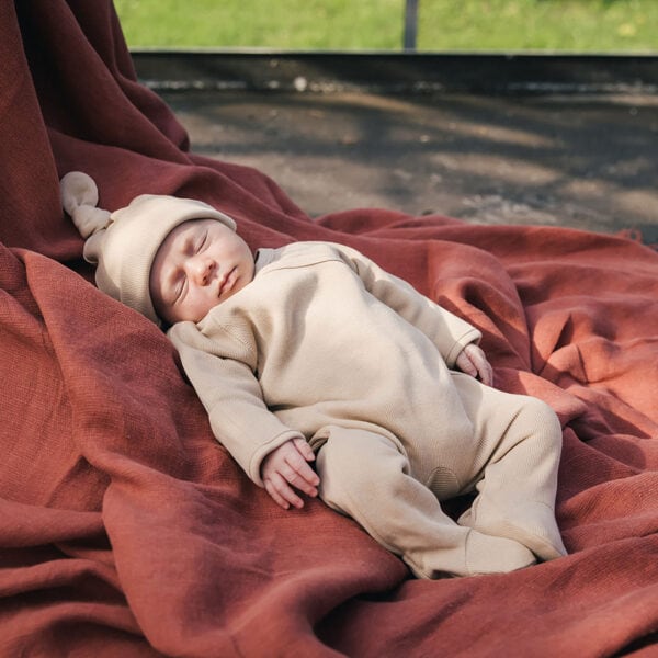 Baby wearing onesie in pima cotton | UAUA Collections