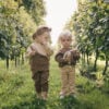 Two baby girls wearing outfits in pima cotton in neutral colours | UAUA Collections