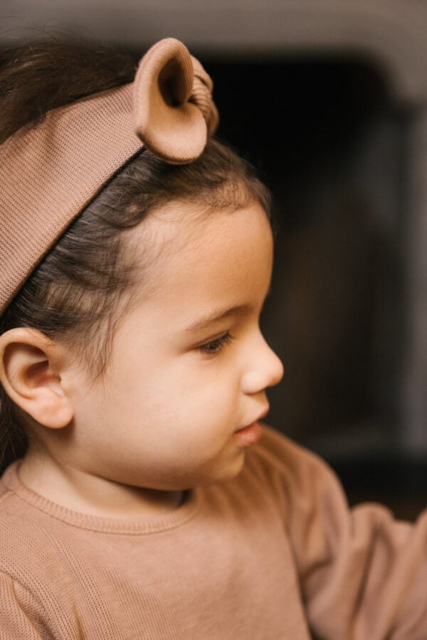 Toddler wearing dress and hair ribbon in pima cotton - biscotti - Puno Collection | UAUA Collections