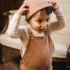 Toddler wearing overall and hat in pima cotton - biscotti - Puno Collection | UAUA Collections