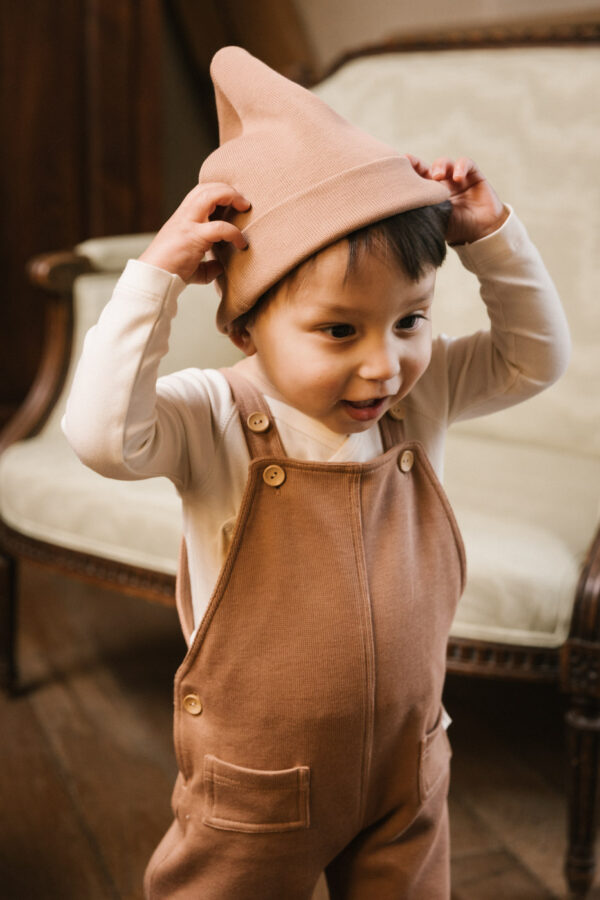 Toddler wearing overall and hat in pima cotton - biscotti - Puno Collection | UAUA Collections